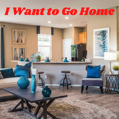 living room decorated in tans and blues with red words "I Want to Go Home"